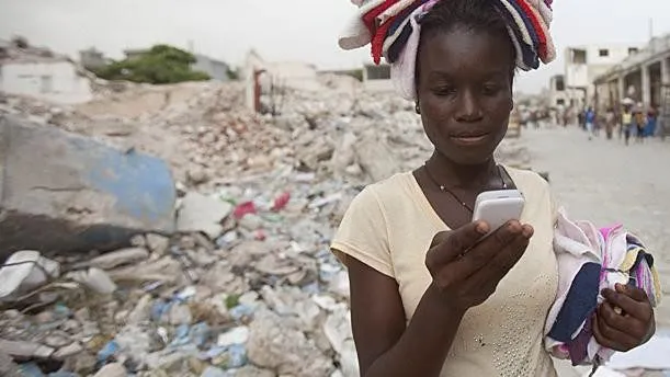 Women in Haiti with her phone