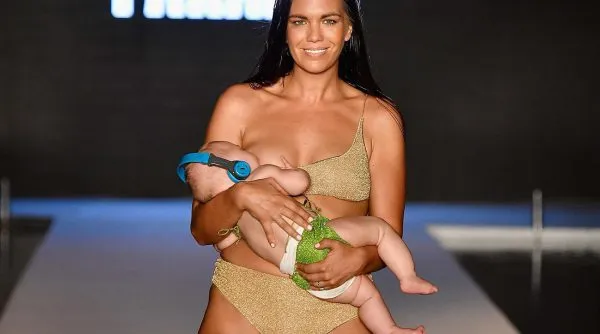model breastfeeds baby runway