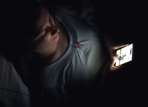 woman using mobile dark
