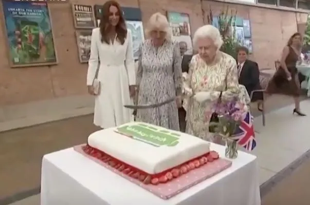 Queen Elizabeth II Cuts Cake With Sword