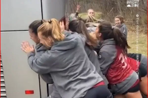 women's lacrosse team pushes bus